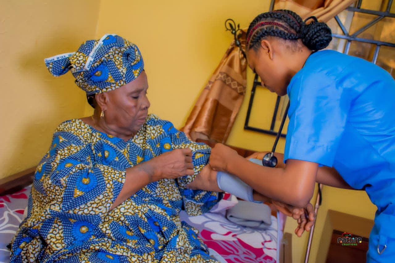 A caregiver helping an older woman during a meal