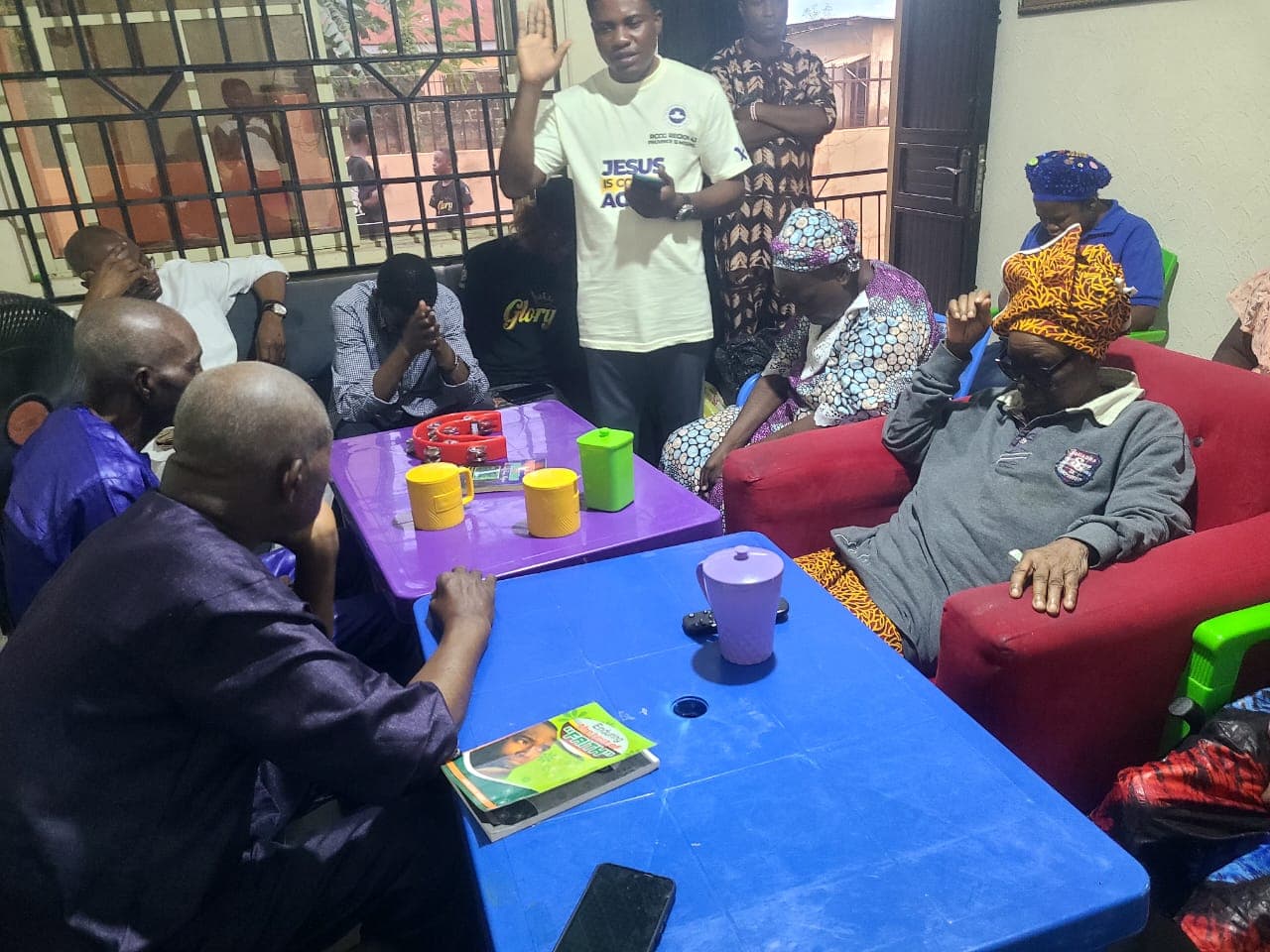 Older people and a team member gathered around a table in the care facility
